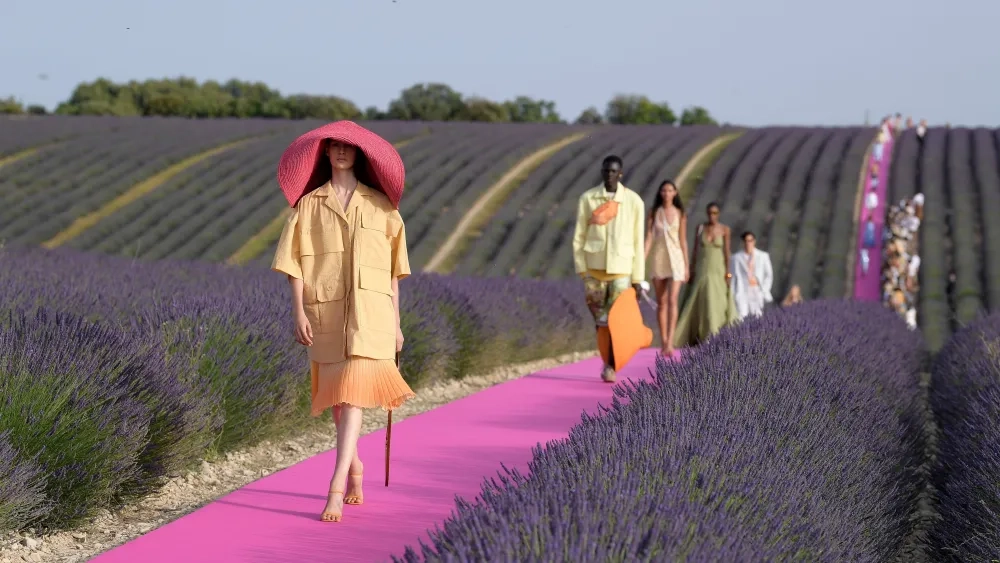 Hot-pink runway laid through a blooming purple lavender field in Valensole, France, for a Jacquemus fashion show.